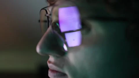 Reflection of artificial intelligence dialogue on glasses of student creating fu Stock Footage 316878296