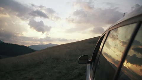 Reflection from auto on amazing mountains at sunset with colorful cloudy sky Stock Footage 284750249