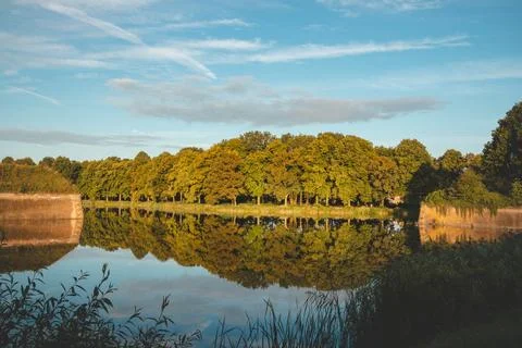 Reflection of autumn trees in the calm surface of a lake near Naarden, Nether Stock Photos