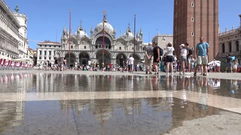 Reflection of the basilica on puddle and strolling tourists Stock Footage 160116053