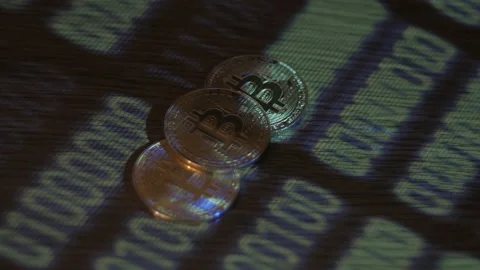 Reflection of binary code on bitcoin coins. Mining of crypto-currencies. Mining Stock Footage 87129783