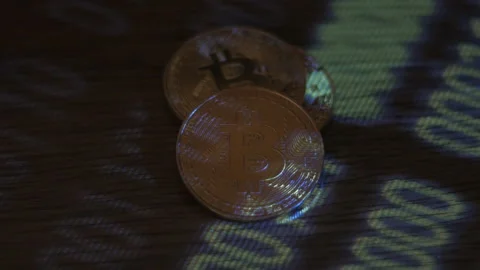 Reflection of binary code on bitcoin coins. Mining of crypto-currencies. Mining Stock Footage 87135693