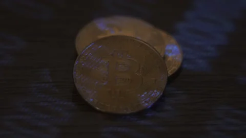 Reflection of binary code on bitcoin coins. Mining of crypto-currencies. Mining Stock Footage 87136627