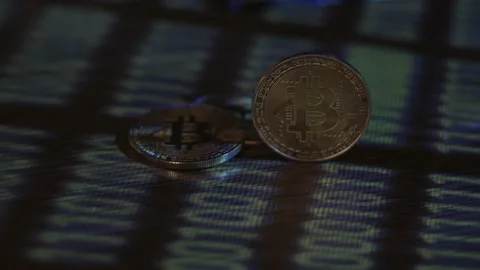 Reflection of binary code on bitcoin coins. Mining of crypto-currencies. Mining Stock Footage 87139505