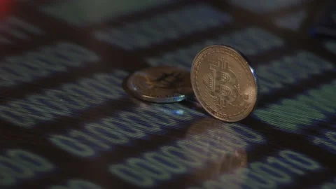 Reflection of binary code on bitcoin coins. Mining of crypto-currencies. Mining Stock Footage 87139816