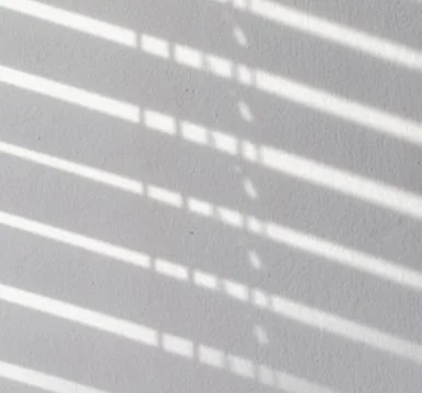 Reflection from the blinds on the wall, texture and structure. light gray shades Stock Photos