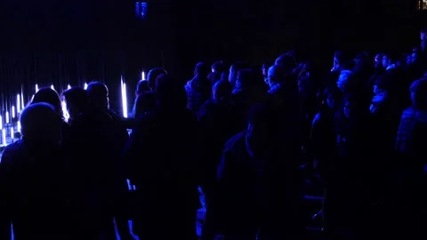 Reflection of blue light on the heads of people who see the play of light Stock Footage 169076743