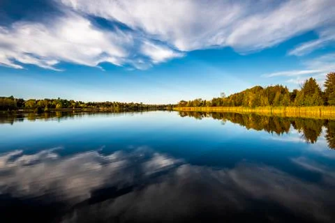 Reflection of blue sky and clouds on a river Stock-Fotos