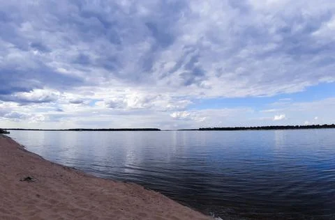 Reflection of the blue sky and clouds in the river. Skyline. Free beach. Stock Photos