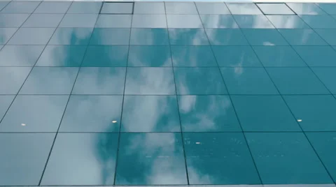 Reflection of blue sky and white clouds on a mirror surface of the glass windows Stock Footage 68369811