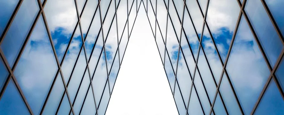 Reflection of blue sky with clouds in an office building window Stock Photos