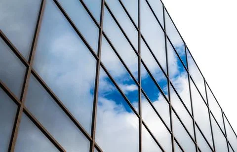 Reflection of blue sky with clouds in an office building window Stock Photos