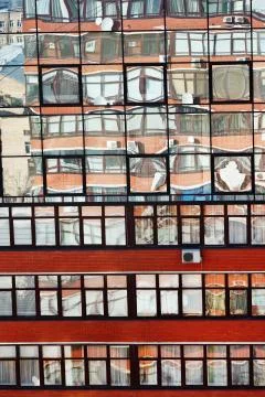 Reflection of brick house in mirror windows Stock Photos