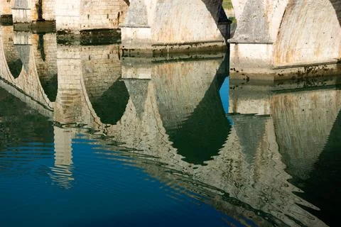 Reflection of bridge on ripple water surface Stock Photos