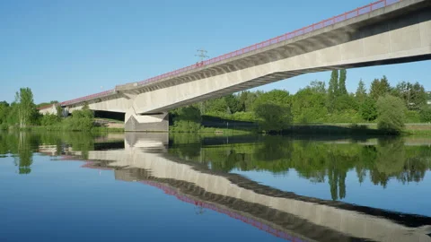 Reflection of bridge in river waves 4k 25p Stock Footage 135392942