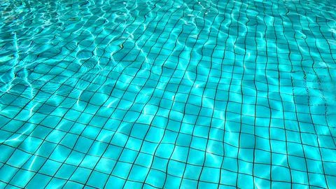 Reflection in a bright blue swimming pool Stock Photos