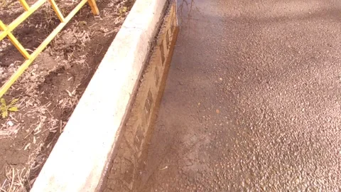 Reflection of the building and the sky in a puddle on the asphalt Stock Footage 240401377