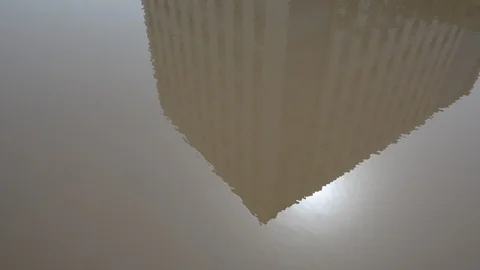 Reflection of building in a mud puddle 動画素材 103477268