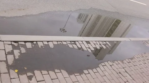 Reflection building in puddle Stock Footage