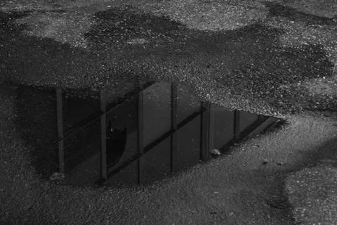 Reflection of a building in a puddle Stock Photos