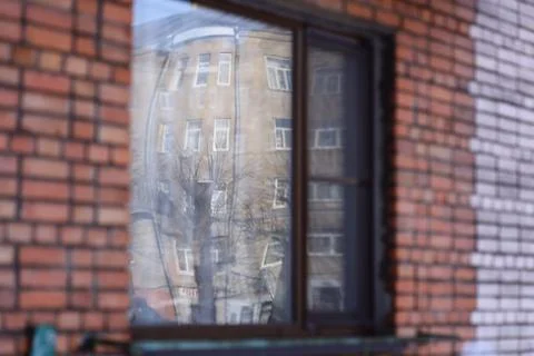 A reflection of a building is visible through a window, providing a unique Stock Photos
