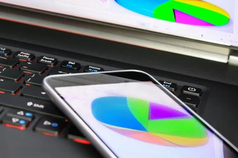 Reflection of  business graph on smartphone Stock Photos