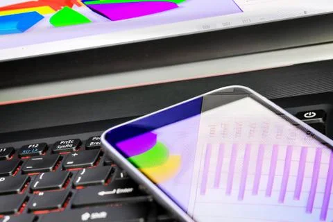 Reflection of  business graph on smartphone Stock Photos