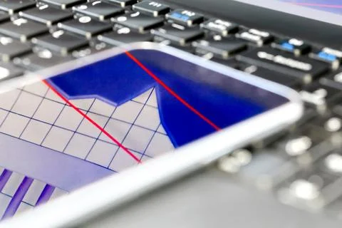 Reflection of  business graph on smartphone Stock Photos