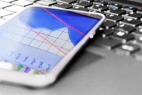 Reflection of  business graph on smartphone Stock Photos