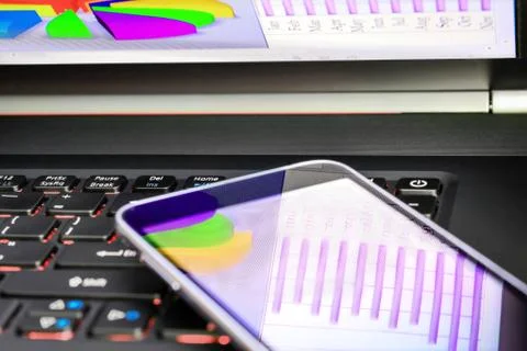 Reflection of  business graph on smartphone Stock Photos