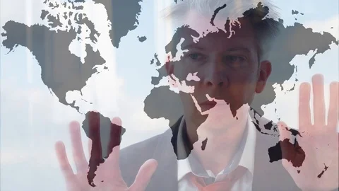 Reflection of a businessman looking at an image of the world Video stock 80932792