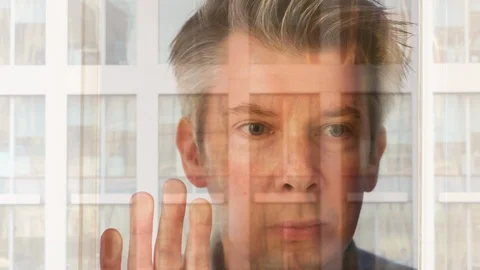 Reflection of a businessman looking at a modern office at night Video stock 104253904