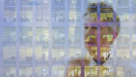 Reflection of a businessman looking out of a window Video stock 80743290