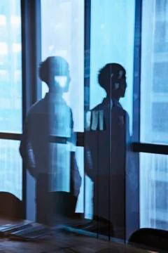 Reflection of businessman looking outside the window Stock Photos