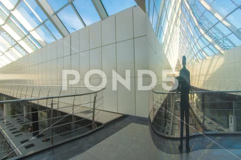 The reflection of the businessman in a mirror column Stock Photos