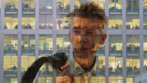 Reflection of a businessman preparing to leave the office Video stock 80742258