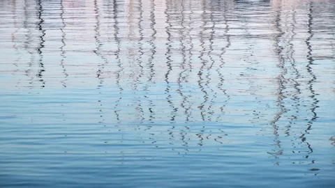 Reflection on the calm blue sea surface high masts of sailing yachts moored Stock Footage 111707949