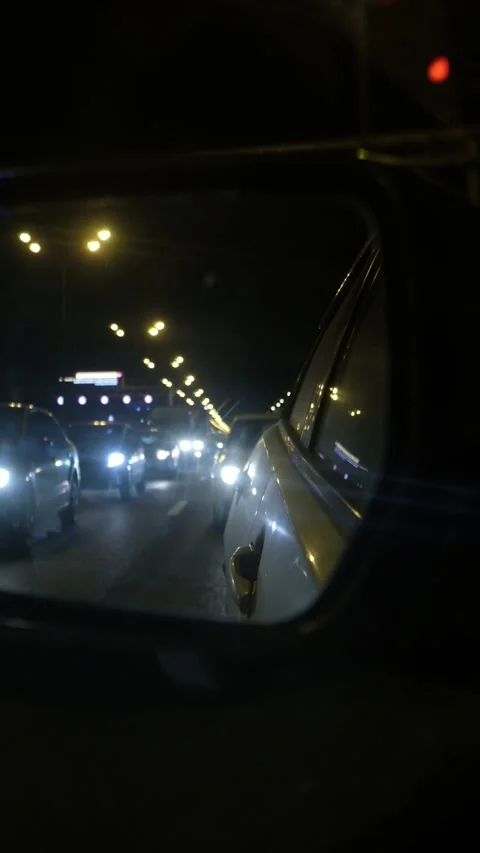 Reflection in a car mirror on night road Stock Footage 171071537