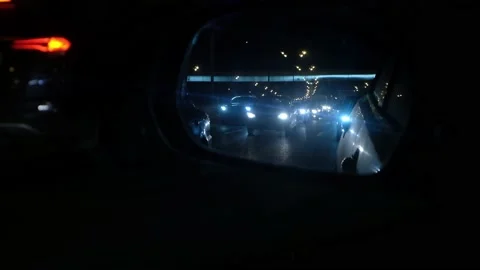 Reflection in a car mirror on night road Stock Footage 171072005