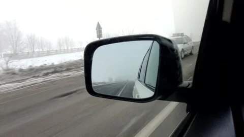 Reflection in car mirror view of winter road Stock Footage 151349801