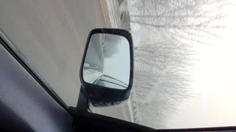 Reflection in car mirror view of winter road Stock Footage 162775425