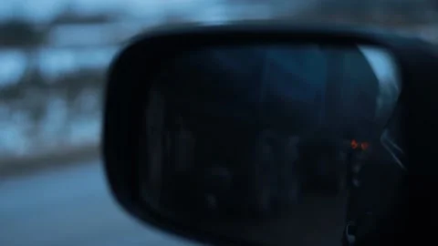 Reflection in the car side mirror of a passing truck on a winter evening Stock Footage 226628255