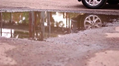 The reflection of the car in the water. The rain drips. Stock Footage 71358847