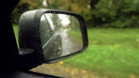Reflection in a car wing mirror of a drive along a rural road. Stock Footage 154372584