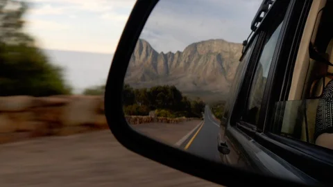 Reflection in car wing mirror with mountain in the mirror. Travel. Travel Vídeo Stock 127642624