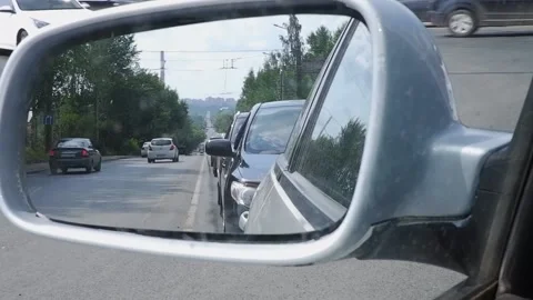 Reflection of cars in the mirror of a passenger car standing in traffic on a  Stock Footage 171681053