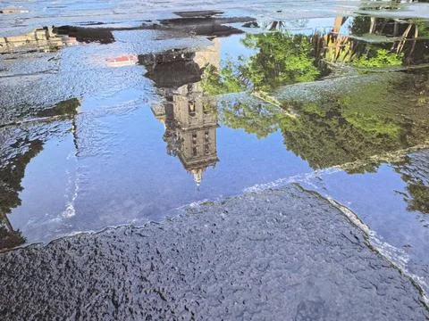 Reflection of cathedral tower in puddle after rain in Puebla Stock Photos