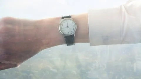 Reflection of a caucasian businessman checking the time Video stock 85155617