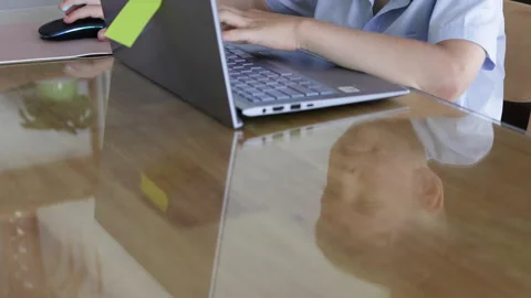Reflection of a child with a laptop on the tables surface. Stock Footage 310218176