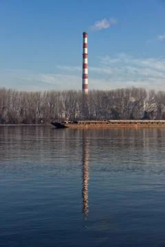 Reflection of a chimney on the river Danube Stock Photos
